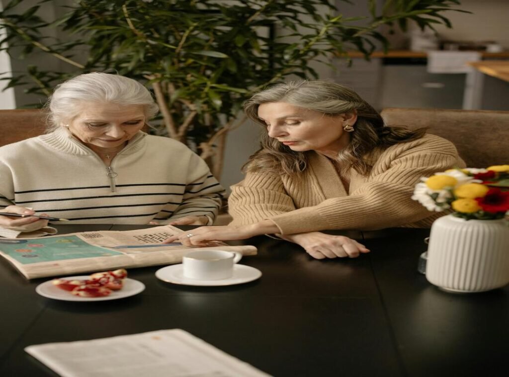 Conversation Around the “bumped things nyt crossword” Puzzle Clue Two elderly women discussing bumped things nyt crossword clue over coffee and a newspaper