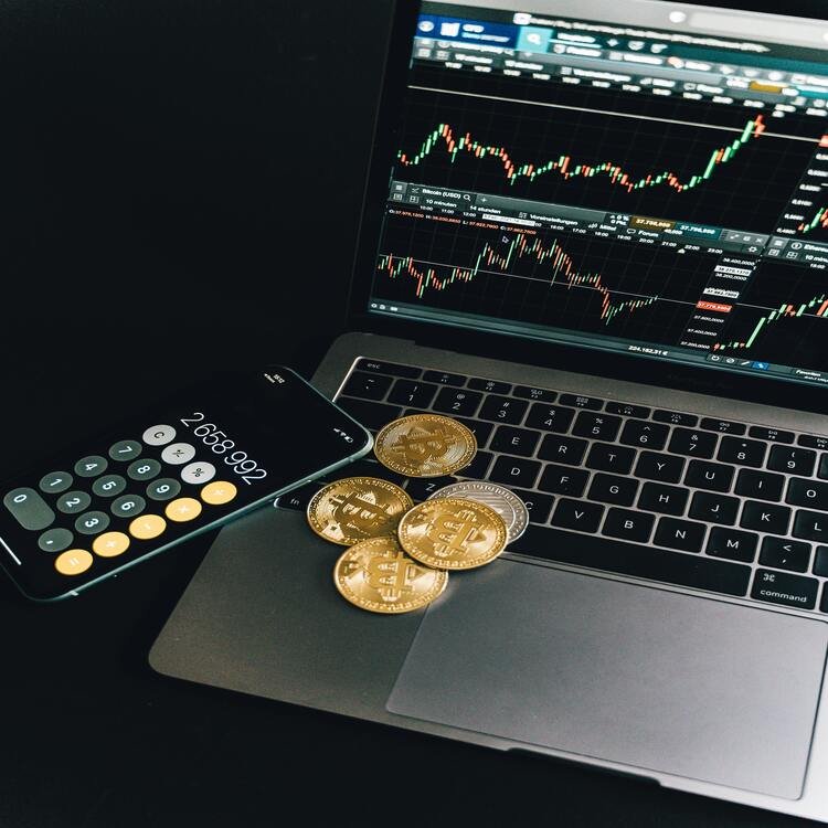 FintechZoom.com Crypto Market Cap Display with Bitcoin and Calculator Laptop showing fintechzoom.com crypto market cap charts with Bitcoin coins and calculator.
