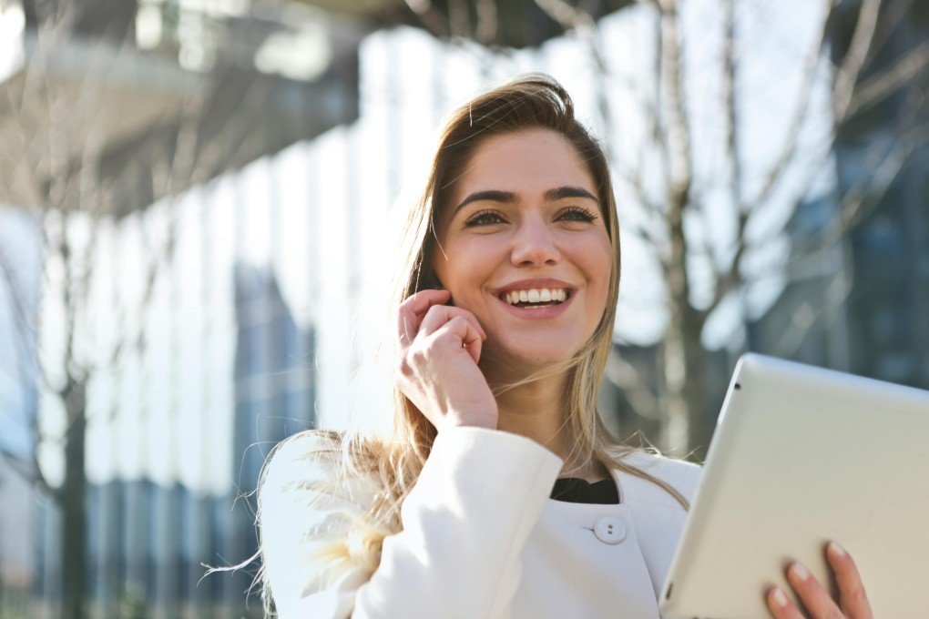 Friendly customer service representative at ProcurementNation.com talking on phone, ready to assist with orders and supplier inquiries