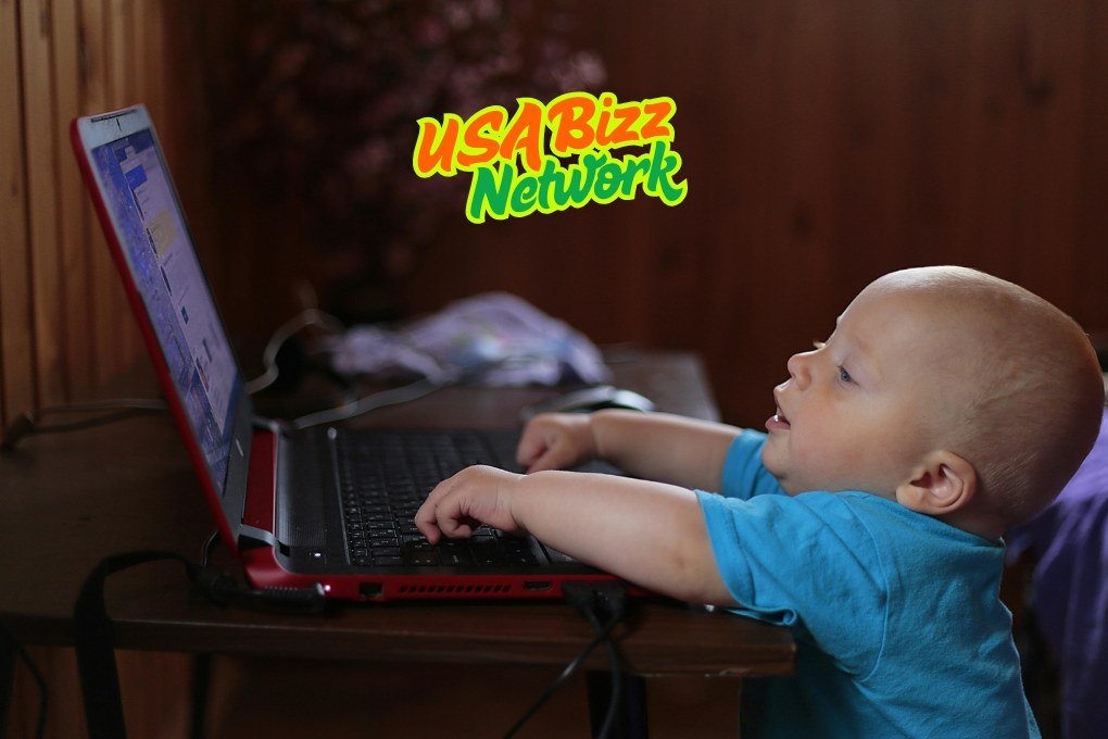 Baby using laptop with essential baby and toddler equipment Lumolog