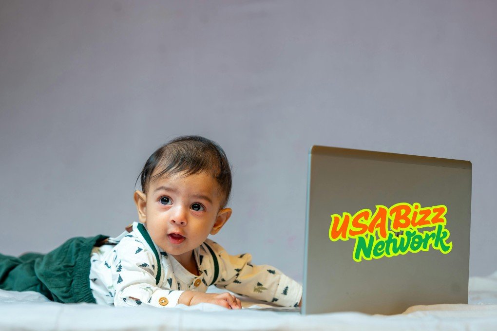 Baby using laptop with essential baby and toddler equipment Lumolog