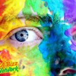 Colorful face paint close-up with blue eyes – Artofzio expression of creativity