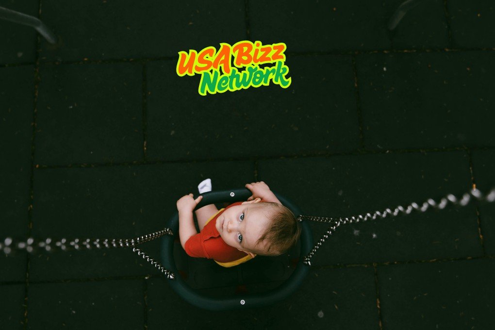 Adorable baby hanging upside down and giggling, safely supported by Lumolog’s essential baby and toddler equipment