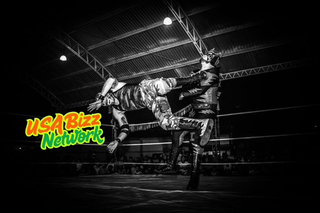 High-Flying Luchador Action – Watch Live on watchwrestling.ae Luchador wrestlers battling in the ring during a high-flying move, streaming live on watchwrestling.ae.