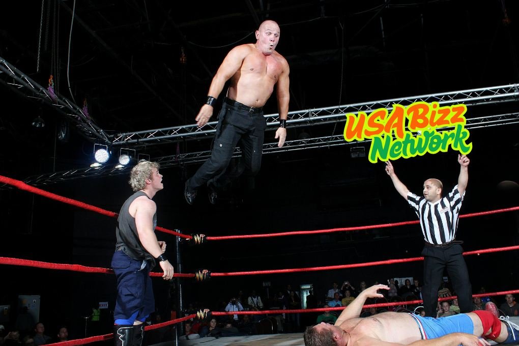 Wrestler performing an aerial move during a match, streaming on watchwrestling.ae for fans of live wrestling.